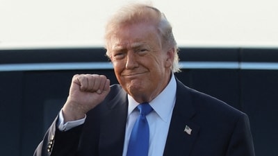 US President Donald Trump raises his fist at Palm Beach International Airport in West Palm Beach, Florida. (REUTERS)