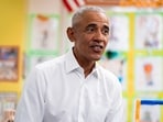 Former US President Barack Obama speaks with students during a visit to Learning Through Play Pre-K in New York