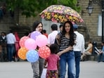 Girls taking a stroll with an umbrella to shield themselves from the scorching sun at The Ridge in Shimla (Deepak Sansta/HT)