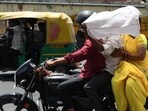 People cover faces to shield from scorching heat in Lucknow on Sunday (Deepak Gupta/HT)