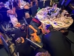 Guests take cover after U.S. President Donald Trump and first lady Melania Trump were rushed out of the White House Correspondents' Association dinner by Secret Service agents when a man opened fire with a shotgun on security personnel outside the room, in Washington, D.C., U.S. April 25, 2026. Picture taken using a mobile phone.  REUTERS/Evan Vucci