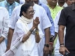 West Bengal chief minister Mamata Banerjee greets supporters during a roadshow in Kolkata. (PTI)