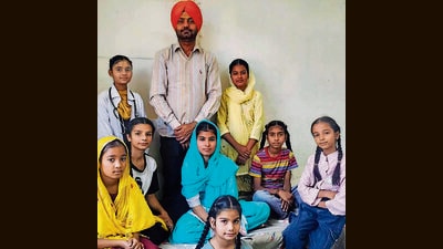 Teacher-cum-filmmaker Karamjit Grewal with the students who acted in the film - Screen Bukhar. (HT PHOTO)