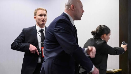 Agents draw their guns after loud bangs were heard during the White House Correspondents' dinner at the Washington Hilton in Washington, DC, on April 25, 2026.(AFP)
