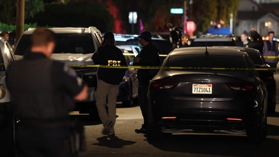 FBI agents walk behind police tape outside the home of the alleged White House Correspondents Dinner shooter in Torrance, California, on April 25, 2026.&nbsp;(AFP)
