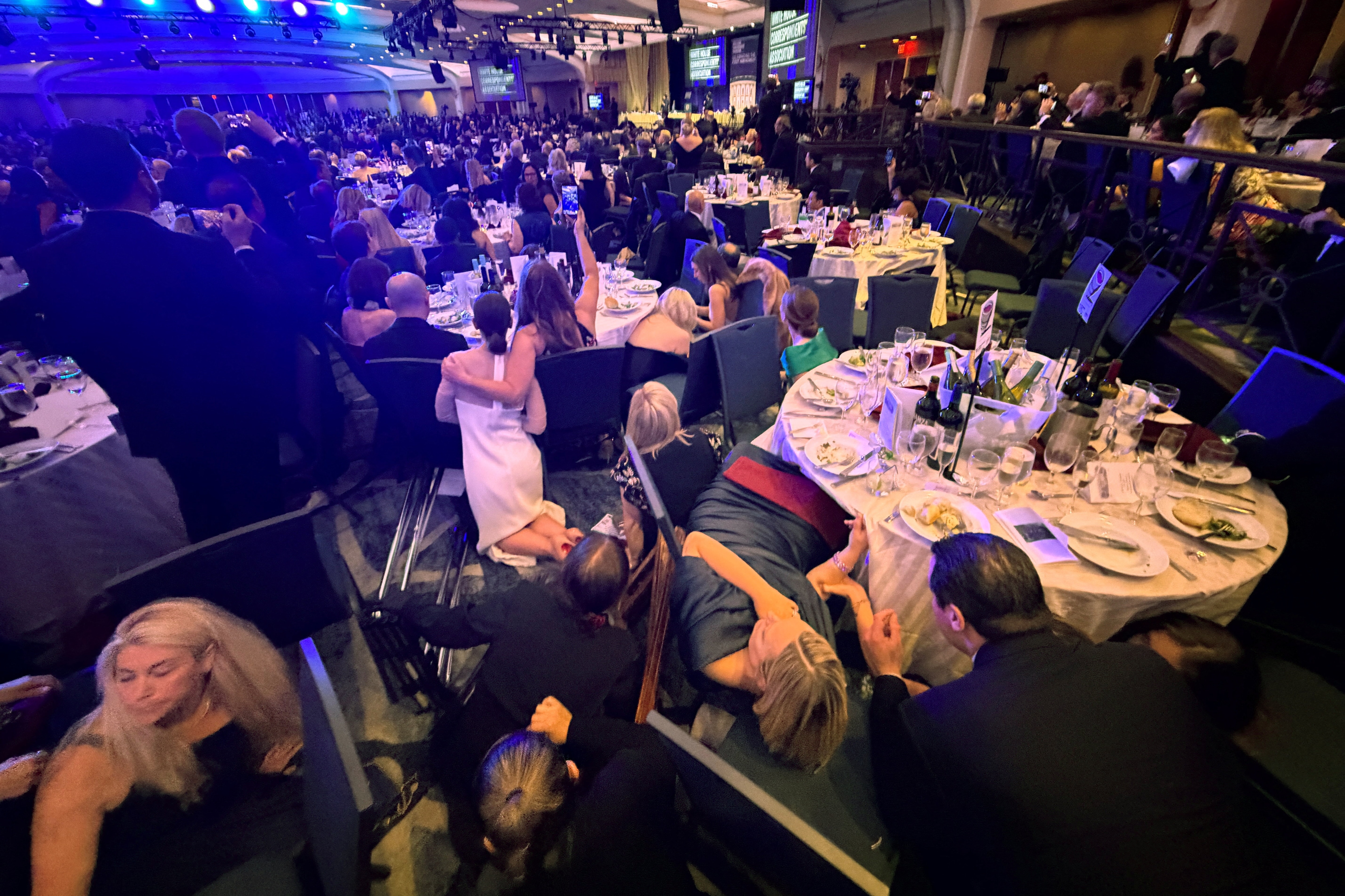 Guests take cover after U.S. President Donald Trump and first lady Melania Trump were rushed out of the White House Correspondents' Association dinner by Secret Service agents after a loud, unidentified noise, in Washington, DC. (REUTERS)