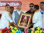 Prime Minister Narendra Modi receives a memento at the public meeting ahead of the second phase of West Bengal Assembly elections at Barrackpore, in North 24 Parganas, on Monday.