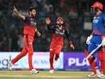 Royal Challengers Bengaluru's Bhuvneshwar Kumar (L) celebrates after taking the wicket of Delhi Capitals Tristan Stubbs (R) during the IPL 2026 match