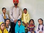 Teacher-cum-filmmaker Karamjit Grewal with the students who acted in the film - Screen Bukhar. (HT PHOTO)