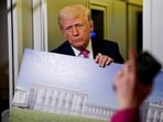 US President Donald Trump talks while holding up renderings of the planned White House ballroom, Maryland, U.S., March 29, 2026. 