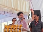 Scindia reached into his pocket and took out an onion to show it to the crowd.