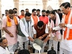 BJP president Nitin Nabin performs rituals as he offers prayers at Kashi Vishwanath Dham, in Varanasi on Tuesday. Union MoS Pankaj Chaudhary (C-L) and UP deputy CMs Keshav Prasad Maurya and Brajesh Pathak also present. (@NitinNabin/ANI Photo)