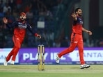 Virat Kohli celebrates after Bhuvneshwar Kumar takes the wicket of Tristan Stubbs.