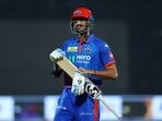 Delhi Capitals' Axar Patel looks dejected and walks back to the pavilion after losing his wicket