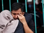 A man is consoled by his wife as he cries while looking for his sister following a deadly collision between a commuter line train and a long-distance train, in Bekasi, on the outskirts of Jakarta, Indonesia, (Reuters)