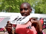 Kenya's Sabastian Sawe celebrates with an Adidas Adizero Adios Pro Evo 3 shoe after setting a world record in the men's marathon.