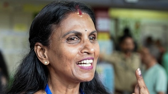 NDA candidate from Vattiyoorkavu constituency, R. Sreelekha shows her ink-marked finger after casting her vote for the Kerala assembly elections, at booth number 104 of Cotton Hill School, in Thiruvananthapuram on Thursday. (@BJP4Keralam X)