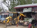 A demolition drive underway against illegal properties built by alleged drug peddlers at Bijbehara in Anantnag district on Wednesday. (PTI Photo) A demolition drive underway against illegal properties built by alleged drug peddlers at Bijbehara in Anantnag district on Wednesday. (PTI Photo)