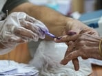 A polling official marks a voter's finger with indelible ink during the second and final phase of the West Bengal assembly elections on Wednesday. (PTI)