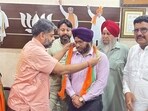 Congress party candidate and worker, Aman Uppal from ward 5, switched over to the BJP with his father and supporters on Tuesday (HT File)