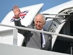 Britain's King Charles III waves as he boards his plane at Joint Base Andrews in Maryland