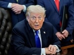 US President Donald Trump takes questions from the media after signing an executive order in the Oval Office at the White House in Washington, DC.