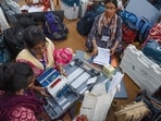 Election officials collect Electronic Voting Machines (EVMs) and Voter Verifiable Paper Audit Trail (VVPAT) machines from a distribution centre ahead of the final phase of voting, in Howrah on Tuesday. Election officials collect Electronic Voting Machines (EVMs) and Voter Verifiable Paper Audit Trail (VVPAT) machines from a distribution centre ahead of the final phase of voting, in Howrah on Tuesday.