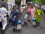 Officials leave for their respective polling stations after collecting Electronic Voting Machine (EVM) and Voter Verifiable Paper Audit Trail (VVPAT) units for voting in the second phase of the West Bengal Assembly elections, in Kolkata.