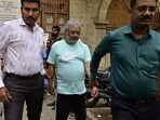 NCB officials escort Dawood Ibrahim’s close aide Salim Dola for medical at NCB office in Ballard Estate in Mumbai. (Anshuman Poyrekar/HT Photo)