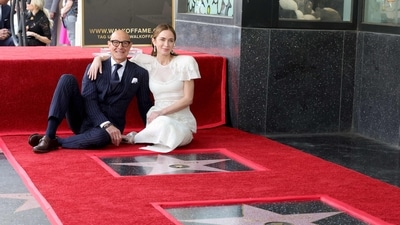 Stanley Tucci and Emily Blunt sat on the felted red carpet, alongside their respective stars, beaming towards the camera and basking in the glory of the occasion. (Getty Images via AFP) Stanley Tucci and Emily Blunt sat on the felted red carpet, alongside their respective stars, beaming towards the camera and basking in the glory of the occasion. (Getty Images via AFP)
