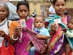 Women show their credentials during Assam assembly elections at a polling station in Guwahati. (PTI Image)