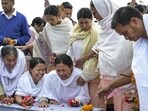 Bereaved family members and relatives perform the last rites of two children, who were killed in a bomb attack in April. (PTI)