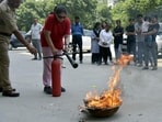 Fire officers conduct a mock drill at Shipra Neo in Indirapuram on Saturday (Sakib Ali / HT)