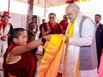 Union Home Minister Amit Shah interacts with a novice monk during the inauguration of the first international exposition of holy relics of Lord Buddha on the occassion of Buddh Purnima, in Ladakh. (PTI)