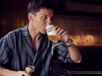 Tom Holland sipping a beverage from his non alcoholic beer brand Bero.