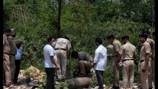 Police personnel at the spot in Manimajra where the body of Krishan Kumar was found on Saturday. (Sant Arora / HT)