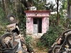 A pink toilet in Mahanagar surrounded by woods and bushes. (Deepak Gupta/HT)