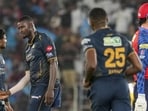 Gujarat Titans' Jason Holder interacts with captain Shubman Gill, left, during the match against Punjab Kings. (PTI)
