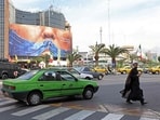 An Iranian cleric walks past an anti-US billboard referring to President Donald Trump and the Strait of Hormuz, installed on a building at the Valiasr Square in Tehran on May 2, 2026. (Photo for representation)