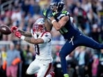 New England Patriots cornerback Christian Gonzalez (0) breaks up a pass intended for Seattle Seahawks wide receiver Jaxon Smith-Njigba