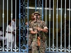 Security personnel stand guard outside the strong room of Khudiram Anushilan Kendra on the eve of counting and results of the West Bengal Assembly polls, in Kolkata