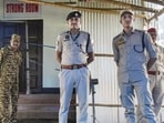 Security personnel of Assam police stand guard outside a strong room storing EVMs. (PTI)