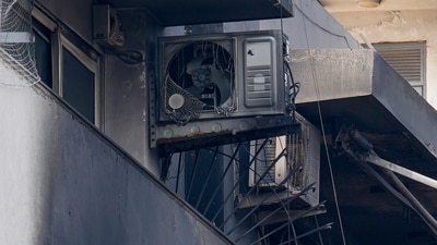 Charred remains of outdoor AC units and other items lie in the balcony of the four-storey residential building where a fire killed at least nine people, at Vivek Vihar area, in New Delhi. (PTI) Charred remains of outdoor AC units and other items lie in the balcony of the four-storey residential building where a fire killed at least nine people, at Vivek Vihar area, in New Delhi. (PTI)