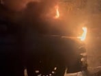 A car was partially burnt and another was slightly damaged around 4.30am in D Block of Sector 27 after a live high-tension power line came in contact with a palm tree and caused fire in i (HT Photos)