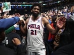 Philadelphia 76ers center Joel Embiid gets congratulated as he leaves the court after their win over the Boston Celtics in game seven of the first round of the 2026 NBA Playoffs at TD Garden.