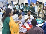 పోస్టల్ బ్యాలెట్ లెక్కింపులో ఎన్నికల అధికారులు(PTI)