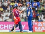 Rishabh Pant, left, interacts with Mumbai Indians' captain Suryakumar Yadav.