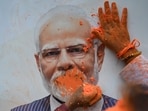 BJP supporters are celebrating by offering colour gulal to a portrait of PM Narendra Modi as their party lead in West Bengal assembly election 2026 