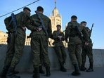 Russian servicemen await the rehearsal of the Victory Day military parade, to be held at Red Square, in central Moscow