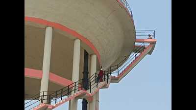 A woman who had climbed an overhead water tank in Prayagraj on Saturday. (HT Photo) A woman who had climbed an overhead water tank in Prayagraj on Saturday. (HT Photo)